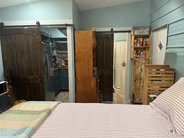 a bedroom with a bed and a closet