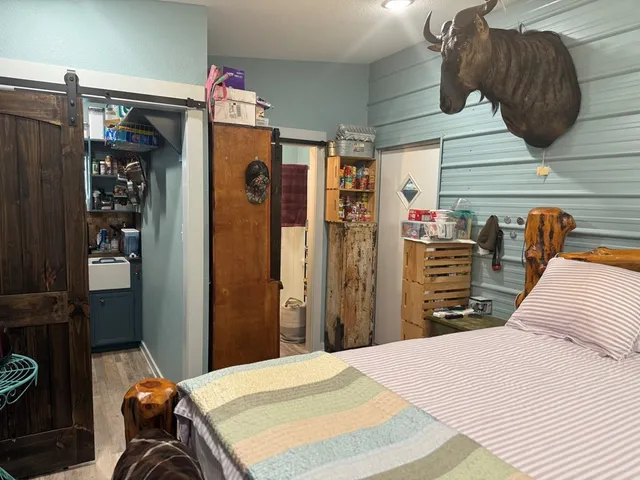 a bedroom with a bed and a dresser