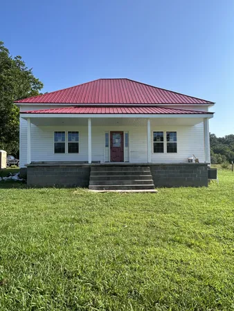 a view of house with backyard and deck