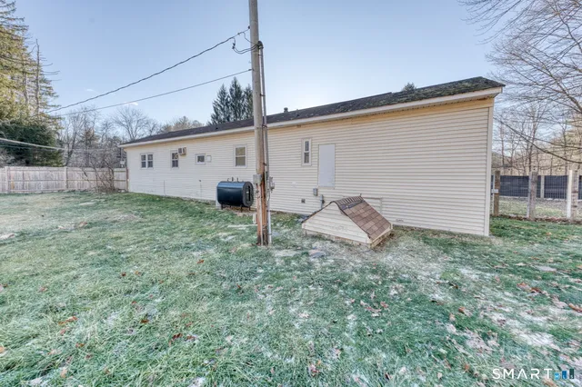 a view of a house with a yard covered in snow
