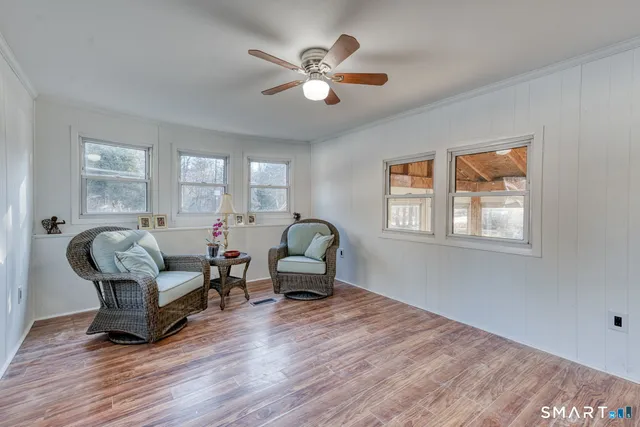 a room with wooden floors and white walls