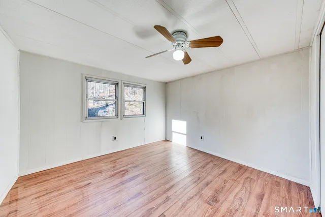 a view of a room with wooden floor