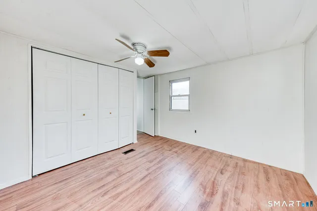 a view of a room with window and wooden floor