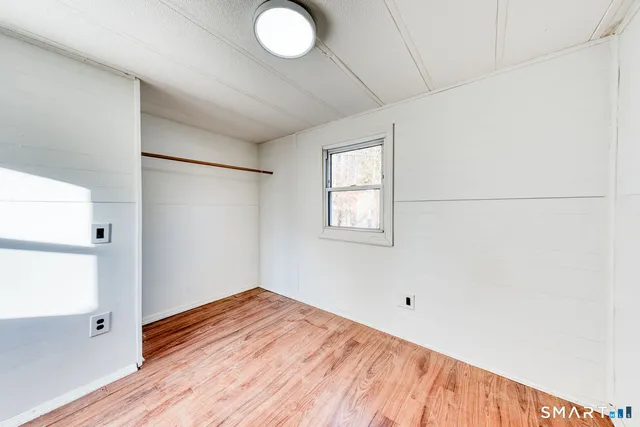a view of a room with wooden floor and cabinet