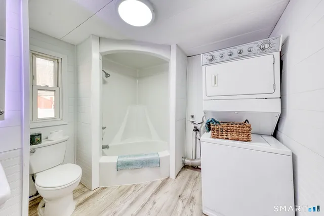 a bathroom with a sink mirror toilet and bathtub