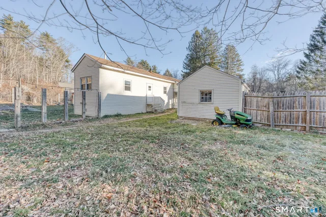 a view of dirt yard with a large tree