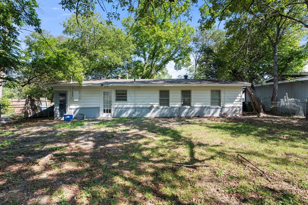 1704 Joyce Street Arlington, TX 76010 - Photo 16 of 19 a view of a house with a yard patio and a tree