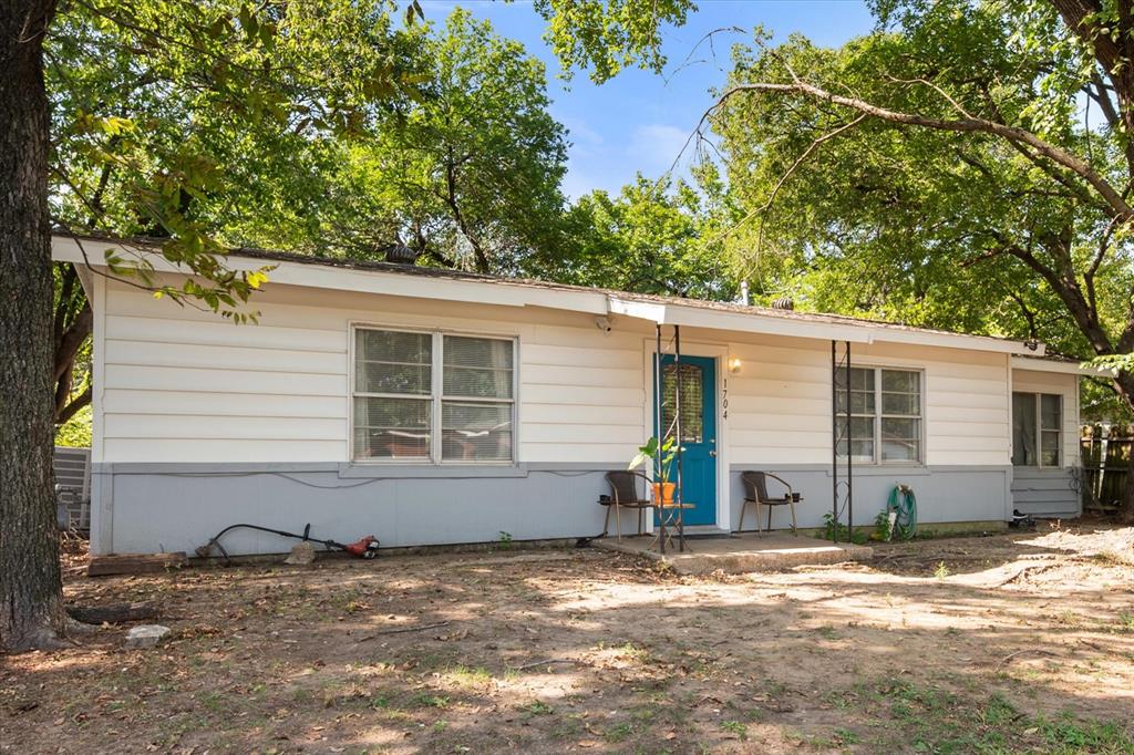 1704 Joyce Street Arlington, TX 76010 - Photo 2 of 19 front view of a house with a yard