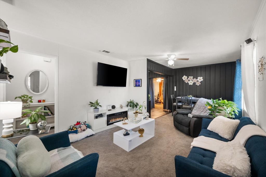 1704 Joyce Street Arlington, TX 76010 - Photo 3 of 19 a living room with furniture fireplace and a flat screen tv