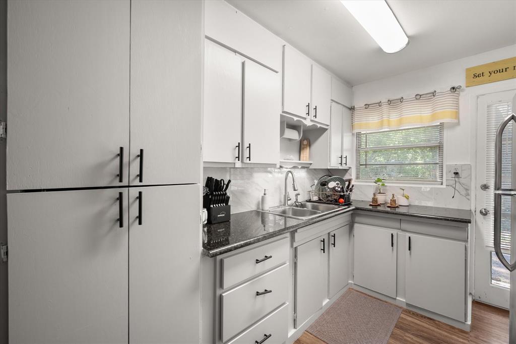 1704 Joyce Street Arlington, TX 76010 - Photo 9 of 19 a kitchen with stainless steel appliances sink a refrigerator and white cabinets
