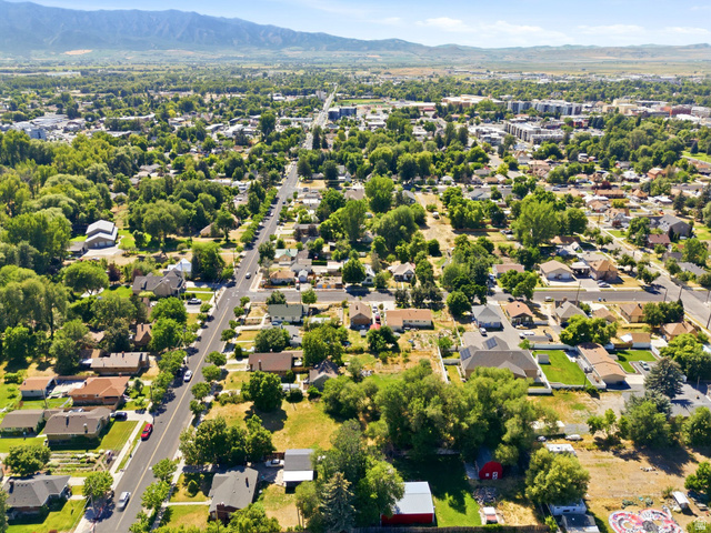 300 East S, Unit 2 Logan, UT 84321 - Photo 25 of 38 Expansive aerial perspective showcasing a residential area with varied housing styles and mature tree coverage