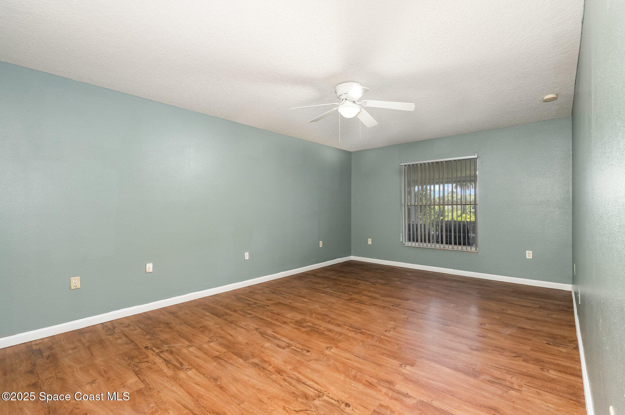 6105 Banyan Street Cocoa, FL 32927 - Photo 13 of 27 wooden floor in an empty room with a window