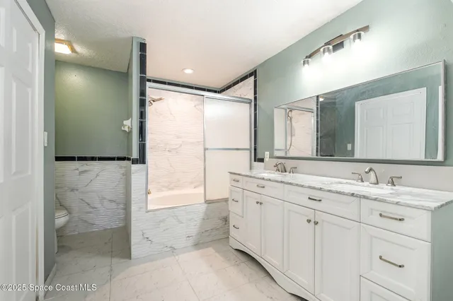 a bathroom with a double vanity sink and a mirror