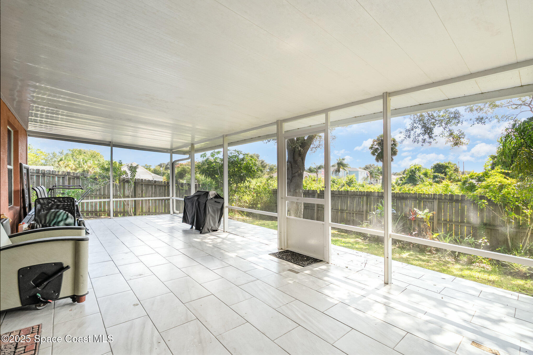 6105 Banyan Street Cocoa, FL 32927 - Photo 25 of 27 a view of a room with a floor to ceiling window and an outdoor view