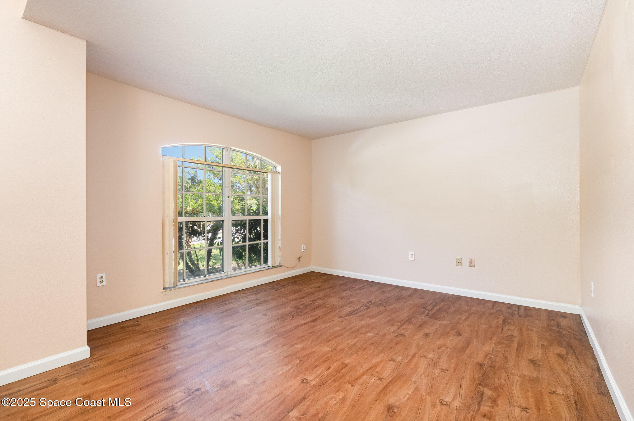 6105 Banyan Street Cocoa, FL 32927 - Photo 7 of 27 an empty room with wooden floor and windows