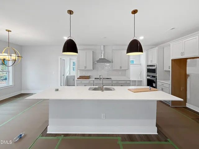 a view of a kitchen with white cabinets