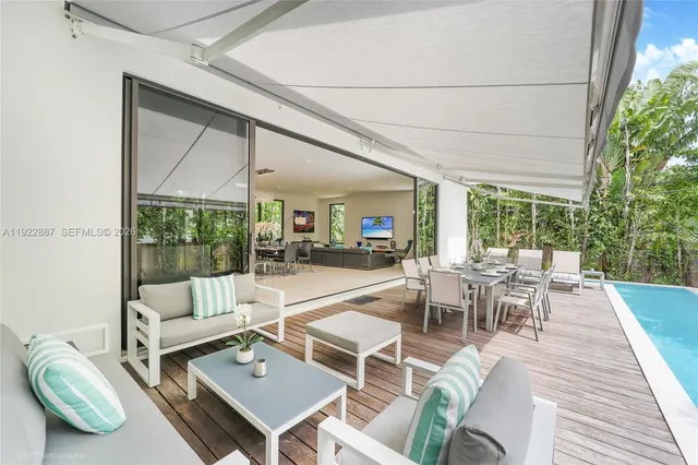 a view of a house with swimming pool and sitting area