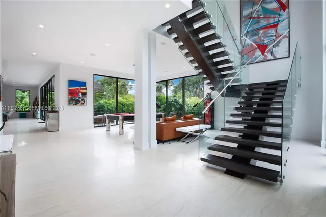 an entryway and livingroom with furniture