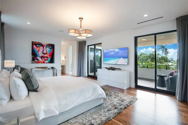 a bedroom with a large bed and a large window