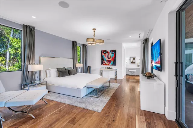 a bedroom with a bed and a mirror