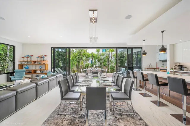 a living room with lots of furniture and a large window