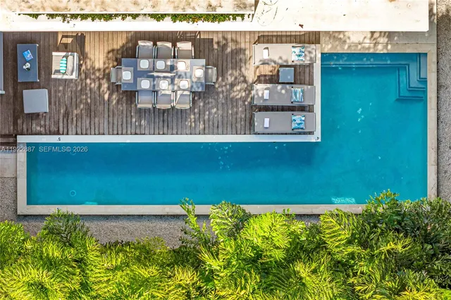 a room with pool table and windows