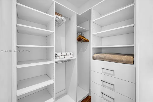 a living room with furniture and view of kitchen