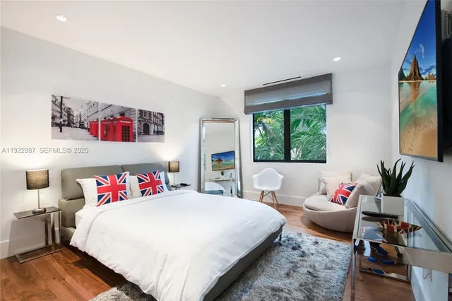 a bedroom with a bed and a large window