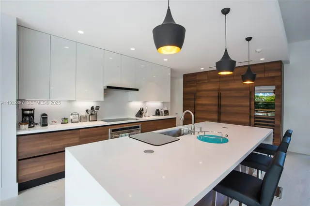 a kitchen with stainless steel appliances granite countertop a sink a stove and a wooden floors