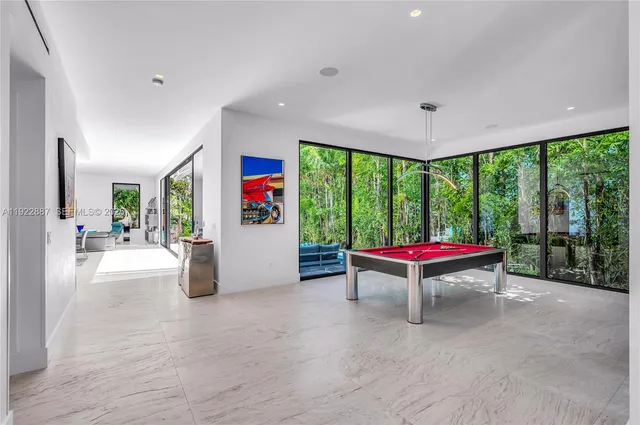 a living room with lots of furniture and a large window