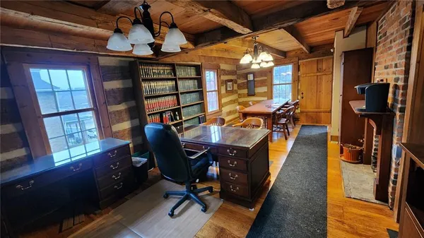 a view of a workspace with furniture and a window