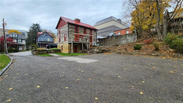 a view of a house with a yard and sitting area