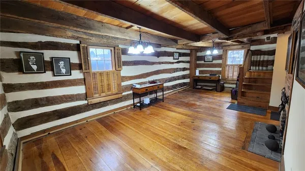 a room with wooden floors and lots of furniture