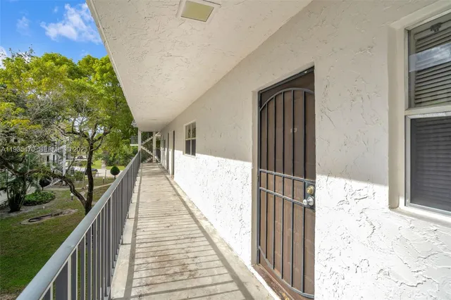 a view of balcony with wooden floor and fence