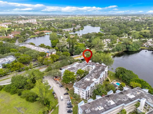 an aerial view of a city with lots of residential buildings lake and ocean view