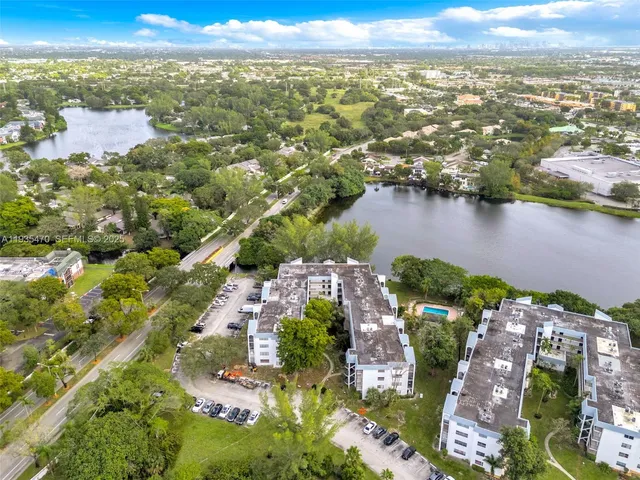 an aerial view of residential building and lake