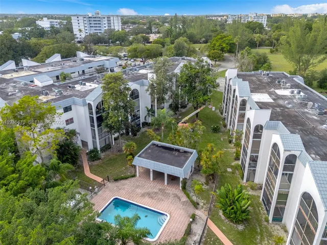 an aerial view of multiple houses with a yard