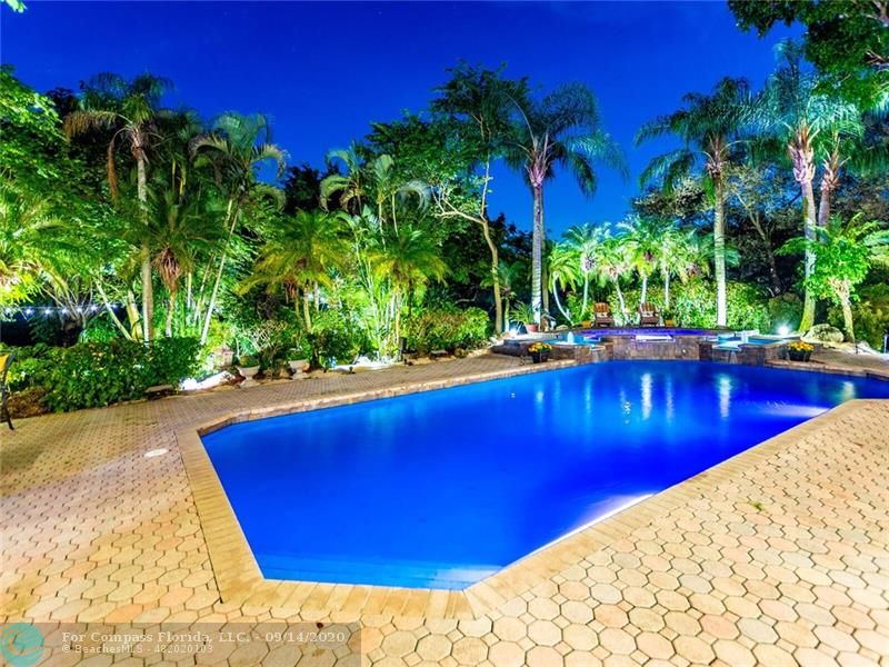 Twilight time in this enchanting setting, with 16x40 salt-chlorinated pool with fiber optic lighting, raised spa, double fountain features, all uplit with twinkling lights! Imagine entertaining here!