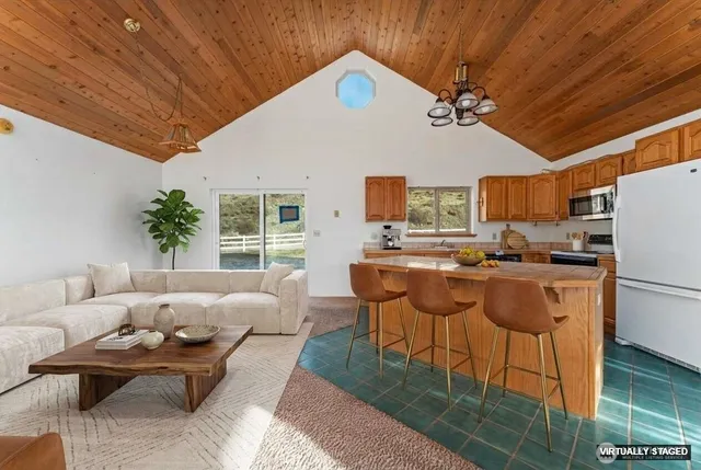a living room with furniture and kitchen view