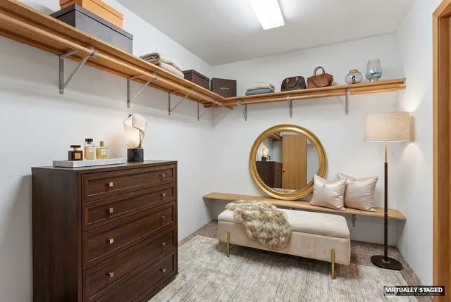 a living room with furniture and a painting on the wall