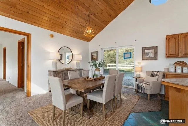 a view of a dining room with furniture and a large window