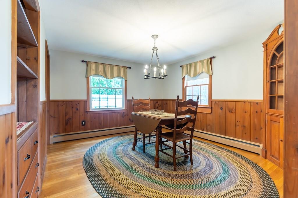 19 Willow Road Boxford, MA 01921 - Photo 14 of 32 a living room with furniture a fireplace and a chandelier