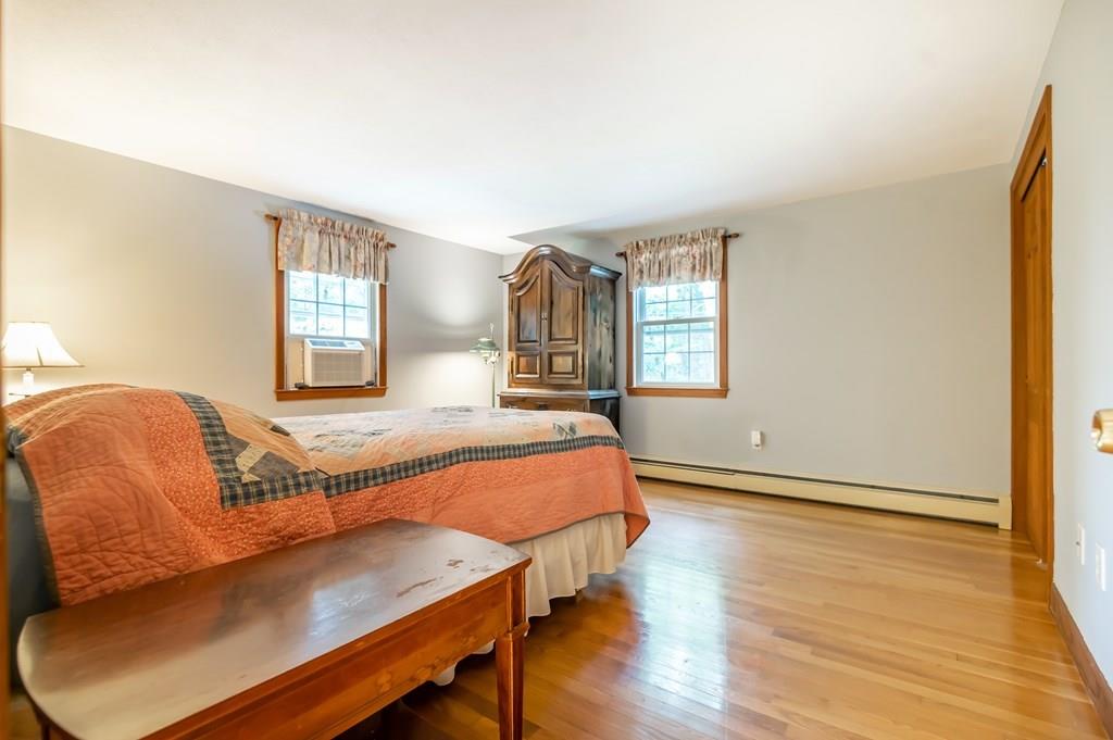 19 Willow Road Boxford, MA 01921 - Photo 19 of 32 a bedroom with a bed and wooden floor