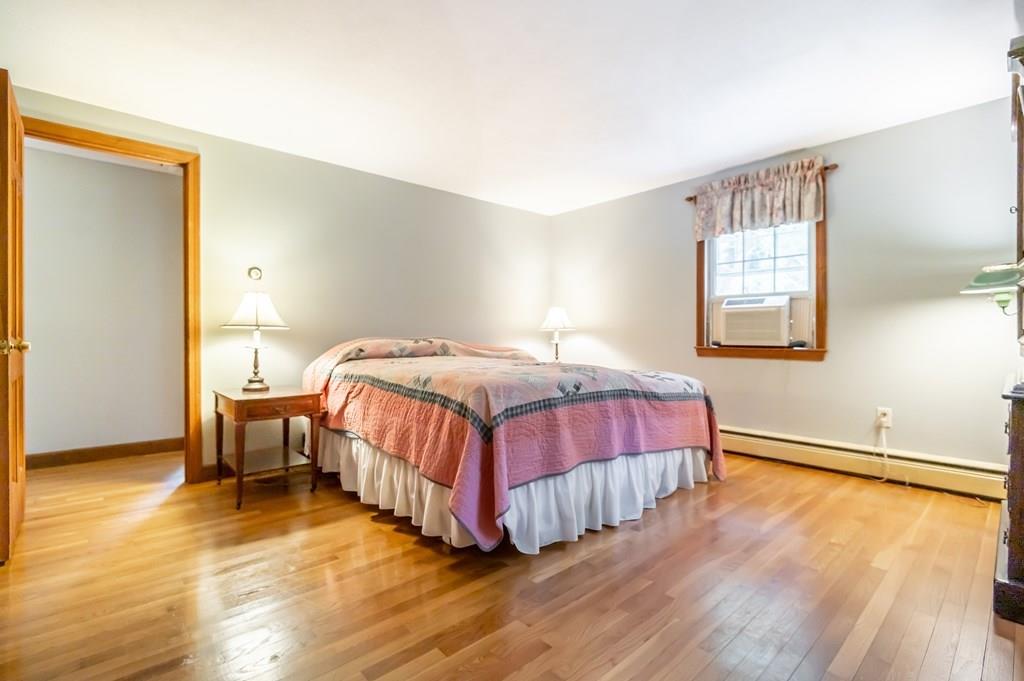 19 Willow Road Boxford, MA 01921 - Photo 20 of 32 a bedroom with a bed and wooden floor