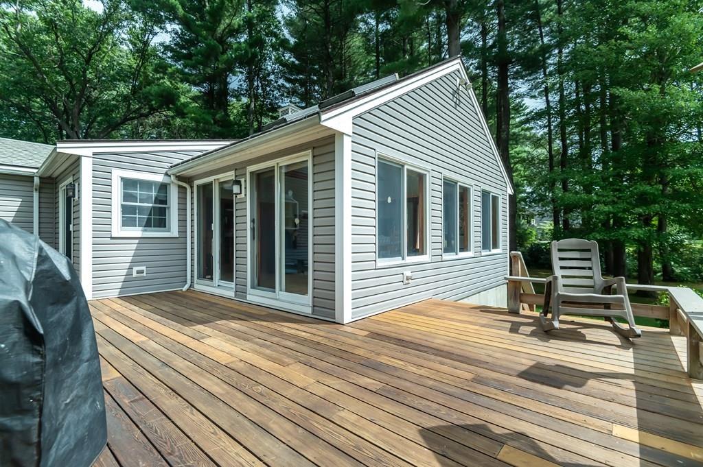 19 Willow Road Boxford, MA 01921 - Photo 5 of 32 a view of a chair and table on the wooden deck