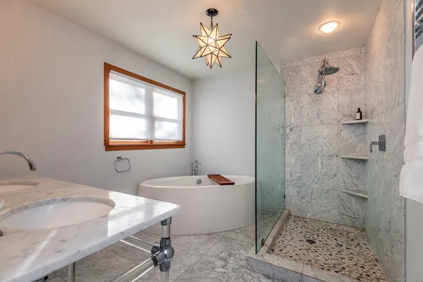 a bathroom with a tub sink and a mirror