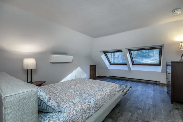 a bedroom with a bed and a night stand