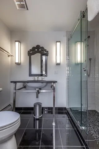a bathroom with a sink toilet and shower