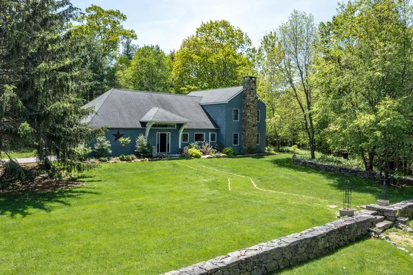 a view of house with a big yard