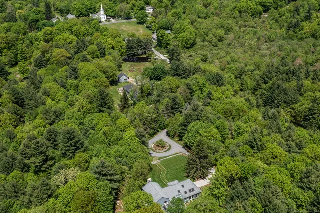 a view of a wooden house with a street sign